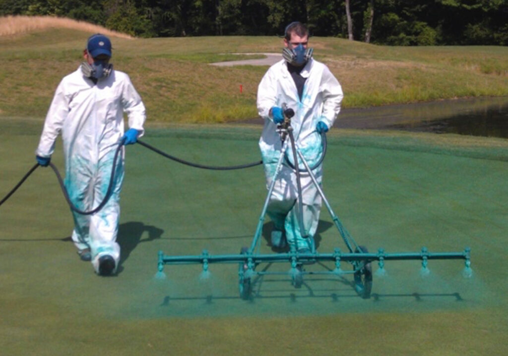 A turf professional applying fungicide to a fairway